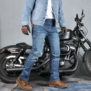 Detail of dark blue vintage motorcycle jeans with reinforced knee seams and wash effect