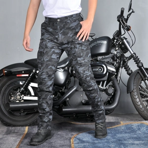 Detail of camouflaged motorcycle cargo pants with multi-pockets and protective gear