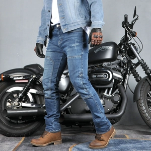 Detail of blue denim motorcycle jeans showing accordion stretch panels on knees and waist