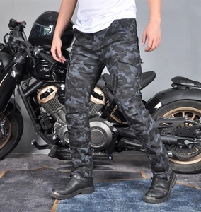 Detail of cargo motorcycle pants with camo print and flexible pleated knee armor panels