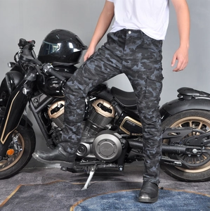 Detail of dark gray camo motorcycle cargo pants featuring flexible pleated knee panels