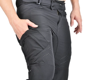 Detail of black motorcycle pants showing breathable laser-cut holes and tactical side pockets