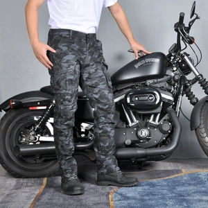 Detailed view of camo motorcycle cargo pants with large utility pockets and knee pads