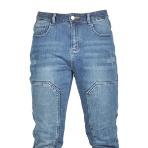 Detail of blue motorcycle riding jeans showing heavy wash texture and cargo stitching