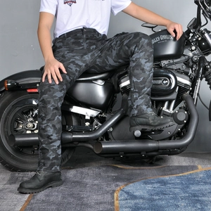Detail of camouflage motorcycle cargo pants featuring multi-pockets and protective fabric