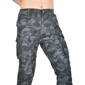 Close-up of camouflage motorcycle pants featuring cargo pockets and durable cotton fabric