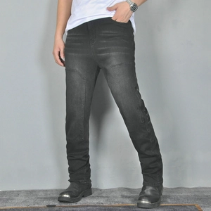 Close-up of vintage dark grey motorcycle jeans with washed finish and stitched panels