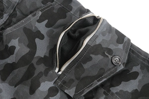 Macro view of camo motorcycle pants featuring metal zipper and breathable mesh lining