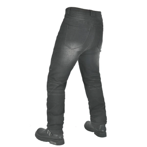 Detail of accordion stretch panels on black wash denim motorcycle pants with riding boots