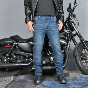 Close-up of durable dark blue motorcycle jeans with knee stitching for men's biking