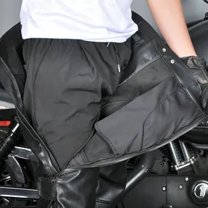 Detail view of motorcycle pants featuring side zippers and protective leather material