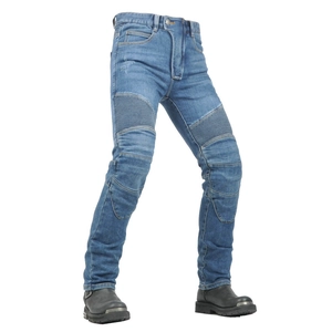 Close-up of blue motorcycle jeans featuring elastic knee pleats tucked into black riding boots