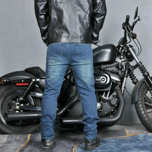 Close-up of mens motorcycle denim pants with reinforced stitching and vintage wash texture