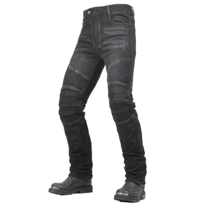 Close-up of motorcycle jeans with accordion stretch panels and black biker boots