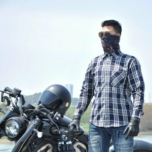 Detail of blue and white plaid motorcycle shirt with chest pocket and riding gloves