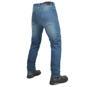 Detail view of motorcycle jeans with durable denim texture and leather waist label