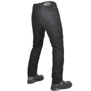 Detail view of reinforced black motorcycle jeans with leather back patch and riding boots