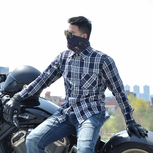 Detail of motorcycle rider in blue plaid riding shirt with protective gear and face mask