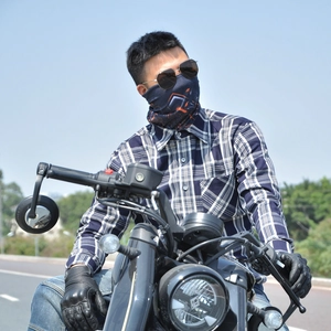 Detail of blue plaid motorcycle shirt with leather gloves and geometric face mask