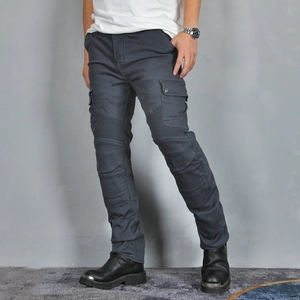 Detail view of reinforced accordion knee panels and cargo pockets on dark grey riding jeans
