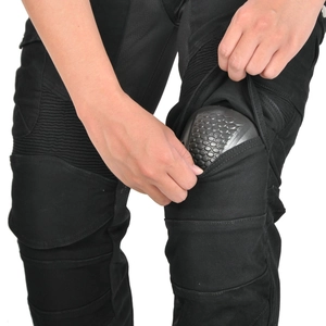Detail of protective honeycomb knee pads on black motorcycle riding jeans
