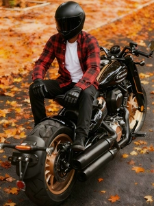 Protective red and black plaid motorcycle shirt for men shown on a classic motorbike