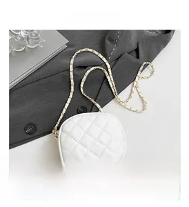 Detail shot of white quilted crossbody bag with rhombic pattern and chain strap