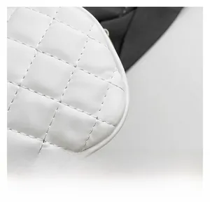 Close-up of white quilted leather bag showing precise stitching and diamond pattern texture