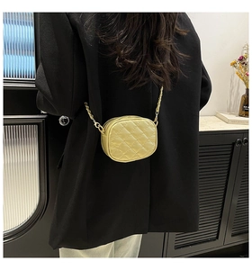 Detailed back view of a yellow quilted mini shoulder bag with a gold chain strap