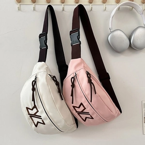 Detail view of stylish white and pink crossbody bags with durable adjustable shoulder straps