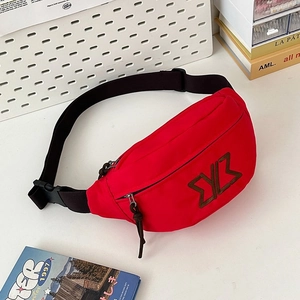 Detail of red nylon waist bag featuring embroidered logo and plastic buckle strap