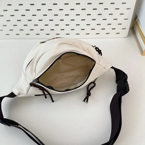 Top view of cream white chest bag showing large interior capacity and zipper detail