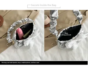 Detail view of silver crossbody bag interior showing main compartment for daily essentials