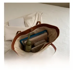 Detail view of large straw tote bag interior showing ample storage for daily essentials