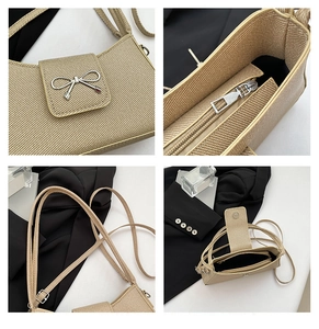 Detail of silver bow hardware and woven texture on a beige baguette shoulder bag