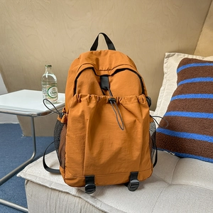 Lightweight caramel brown oxford backpack with drawstring front pocket and large capacity