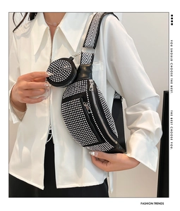 Detail of black rhinestone crescent bag with herringbone strap and round coin purse