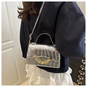 Silver crocodile textured crossbody bag with decorative chunky gold chain detail