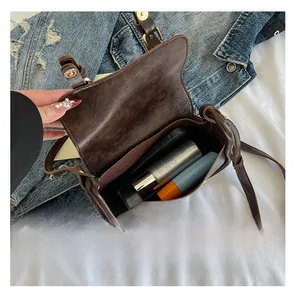 Detail view of the spacious inner compartment of this vintage dark brown square bag