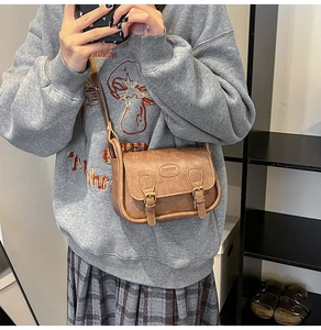 Brown vintage faux leather crossbody bag worn by model showing size and fit