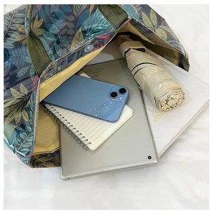 Interior detail of large tote bag showing ample space for tablet, umbrella and phone