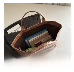 Interior view showing large capacity of metallic bronze tote bag with everyday items