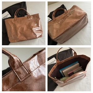 Detail view of large transparent tote bag with brown woven texture inner and ample capacity