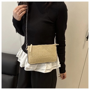 Détail du tissage du sac en paille avec bordure de perles argentées et bandoulière chaîne