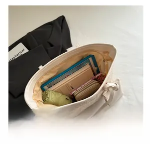 Interior view showing the large capacity of the woven tote bag with daily essentials