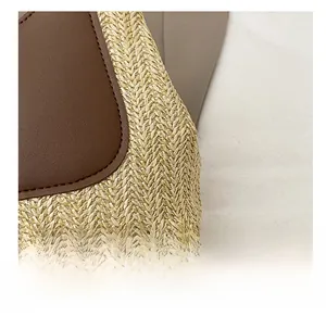 Macro shot of V-pattern straw weaving and brown leather stitching on a summer tote bag