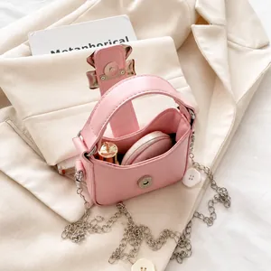 Detail view of pink bow clasp mini bag showing interior capacity for lipstick and makeup
