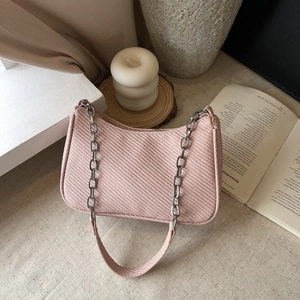 Pink corduroy underarm bag with silver chain strap and minimalist retro design