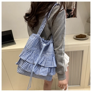 Blue and white gingham tote bag featuring triple ruffles and drawstring closure detail