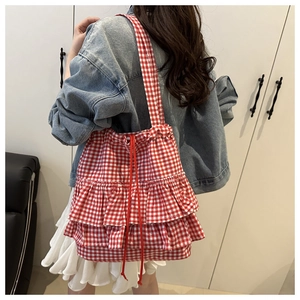 Detail of red and white plaid ruffled tote bag showing lace tiers and drawstring closure
